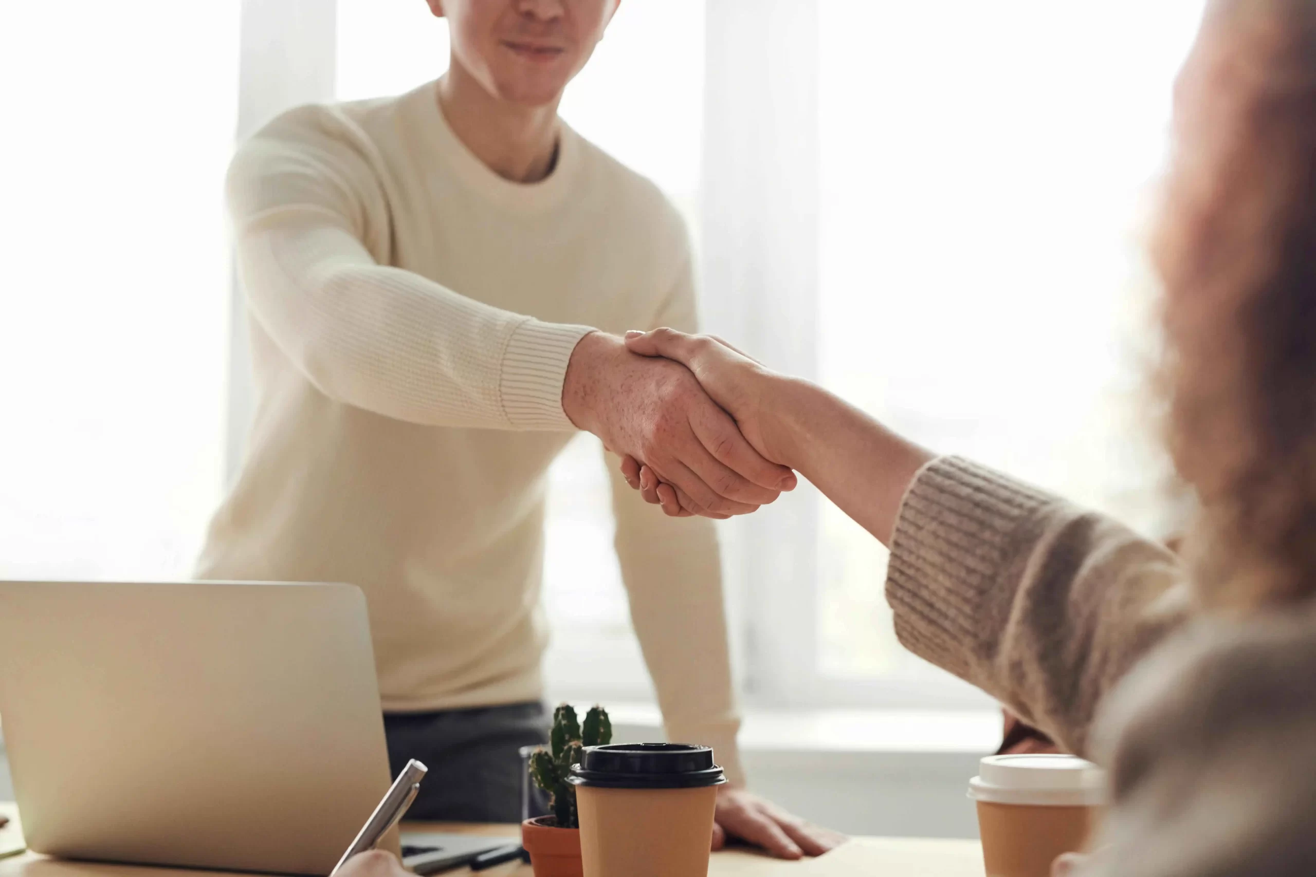 Recruiter handing a document to an experienced candidate, symbolizing lateral hiring success