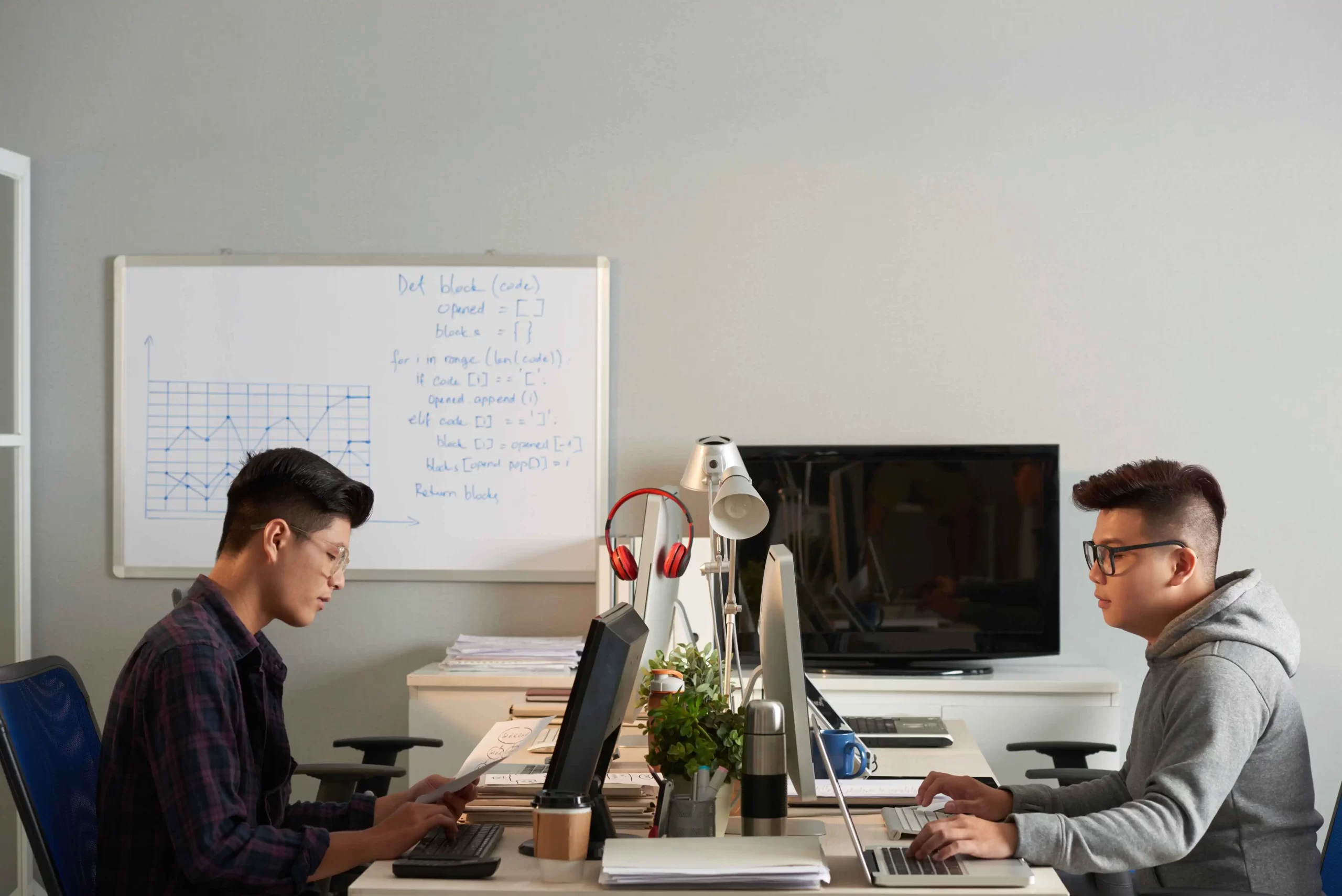 A recruitment consultant working with a client, discussing customized recruitment strategies and solutions in a modern office setting