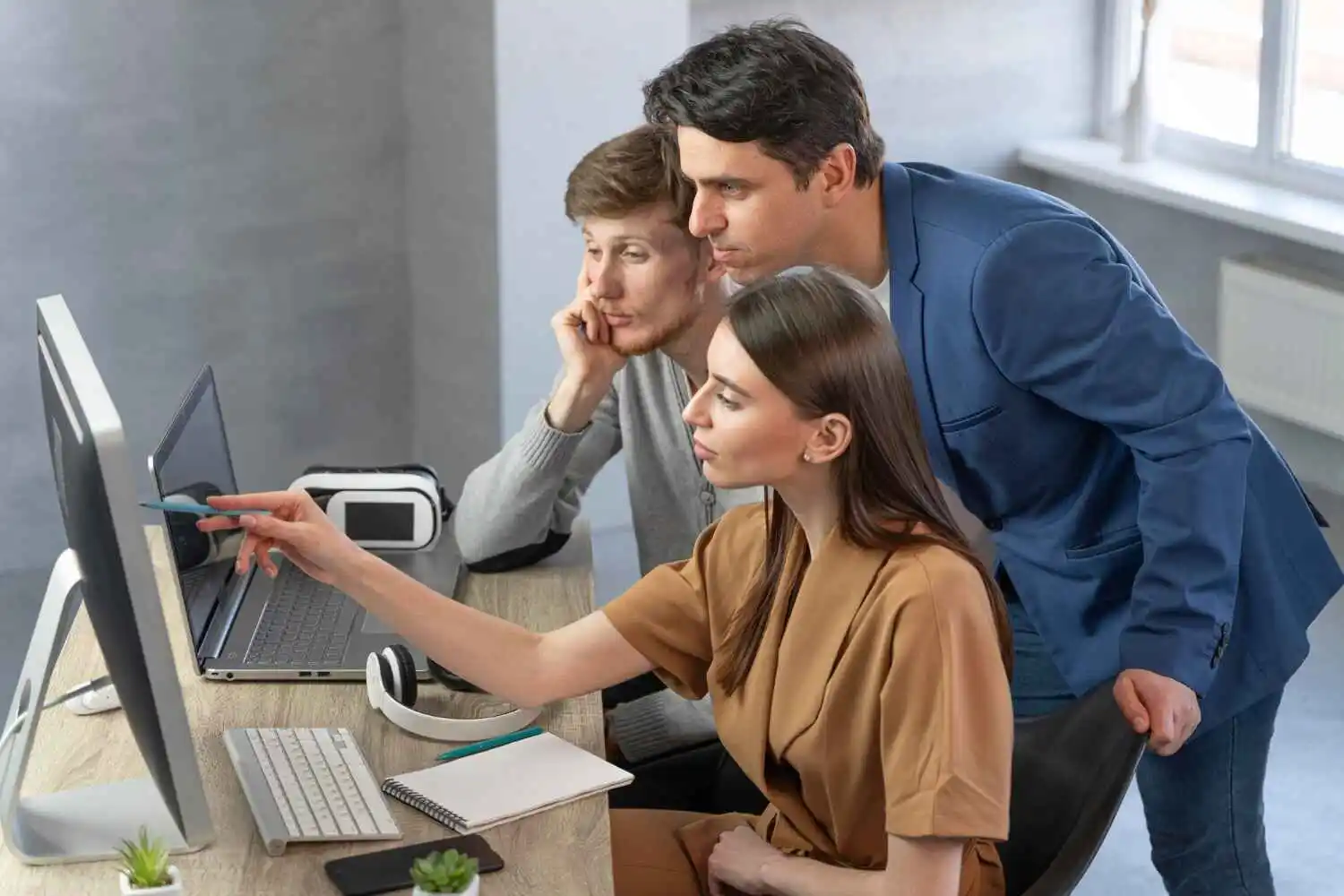 IT professionals collaborating in a tech office, brainstorming or working on computers